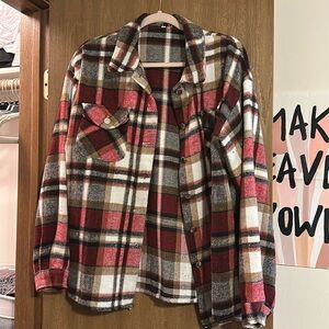 Red, navy, tan, and white flannel from a boutique in Nebraska. Size L